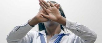 Girl hides her face with her hands