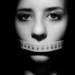 The girl covered her mouth with a centimeter