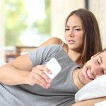 husband looking at smartphone