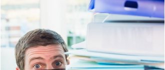 man hiding behind his desk