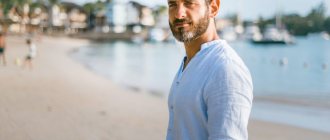 A man stands on the seashore